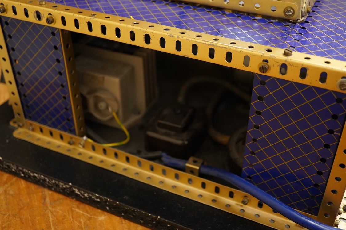 A Meccano model of a fairground ride, incorporating an electric motor in the base and lighting throughout, built in the style of a shop display centrepiece, approx 106cm high, 85cm diameter